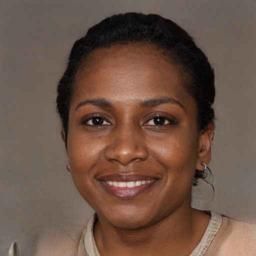 Joyful black young-adult female with short  black hair and brown eyes