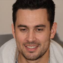 Joyful white adult male with short  brown hair and brown eyes