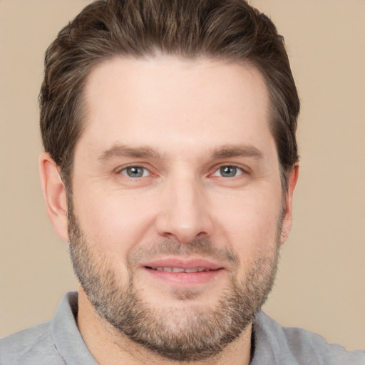 Joyful white adult male with short  brown hair and brown eyes