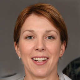 Joyful white adult female with short  brown hair and grey eyes