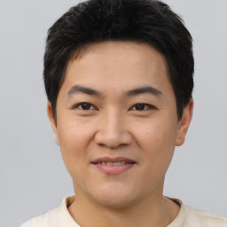 Joyful asian young-adult male with short  black hair and brown eyes