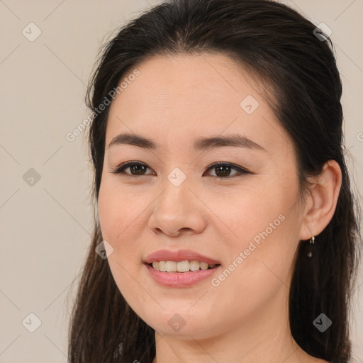 Joyful white young-adult female with long  brown hair and brown eyes