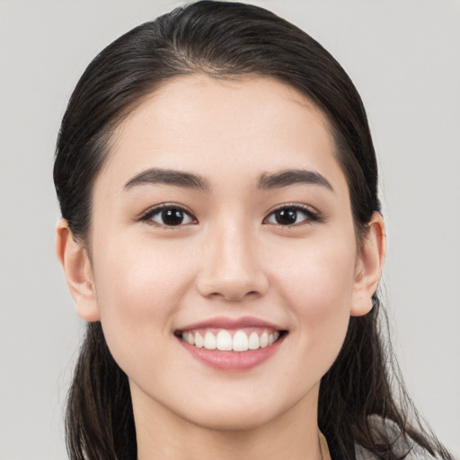 Joyful white young-adult female with long  black hair and brown eyes