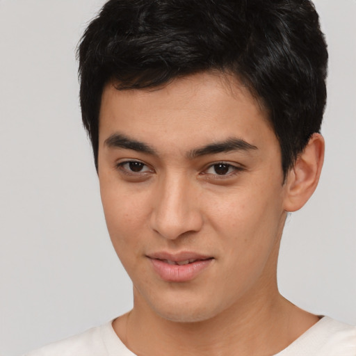 Joyful asian young-adult male with short  black hair and brown eyes