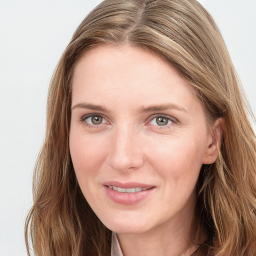 Joyful white young-adult female with long  brown hair and blue eyes