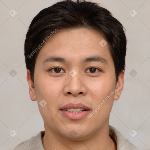 Joyful asian young-adult male with short  brown hair and brown eyes