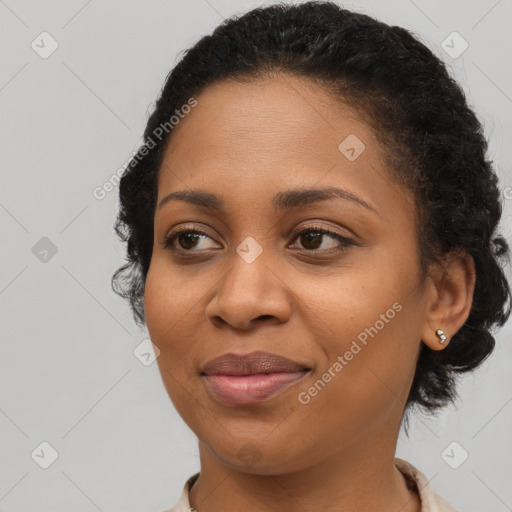 Joyful black young-adult female with medium  brown hair and brown eyes