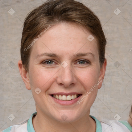 Joyful white adult female with short  brown hair and grey eyes