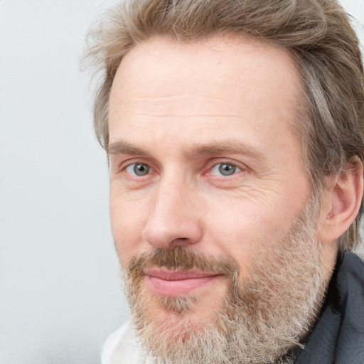 Joyful white adult male with short  brown hair and grey eyes