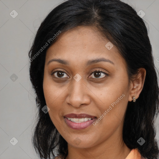 Joyful black young-adult female with long  brown hair and brown eyes