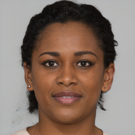 Joyful black young-adult female with short  brown hair and brown eyes
