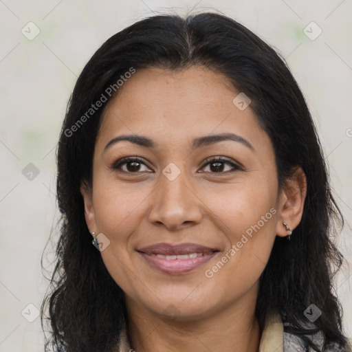 Joyful latino adult female with medium  brown hair and brown eyes