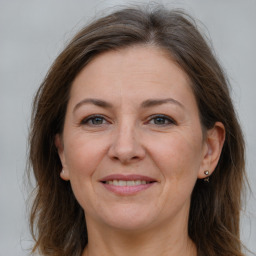 Joyful white adult female with long  brown hair and brown eyes