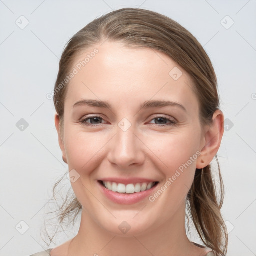 Joyful white young-adult female with medium  brown hair and grey eyes