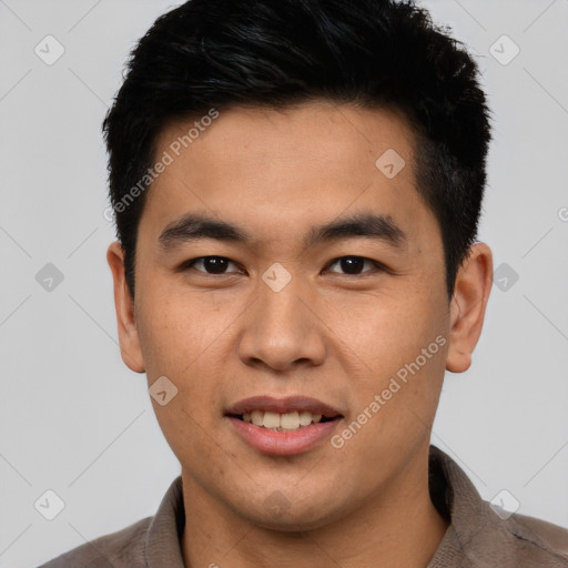 Joyful asian young-adult male with short  brown hair and brown eyes