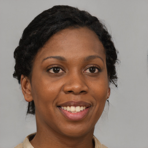 Joyful black adult female with medium  brown hair and brown eyes