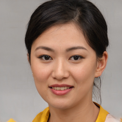 Joyful asian young-adult female with medium  brown hair and brown eyes