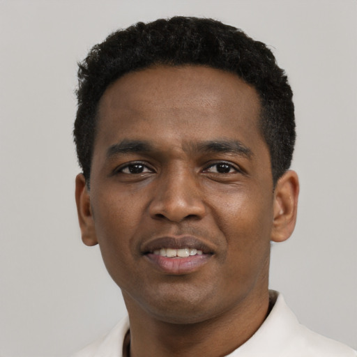 Joyful black young-adult male with short  black hair and brown eyes