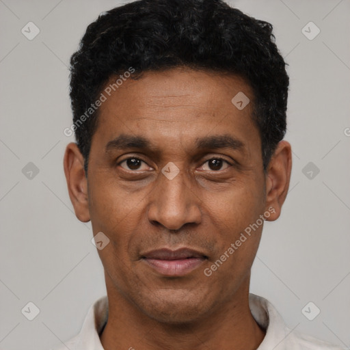 Joyful latino adult male with short  black hair and brown eyes