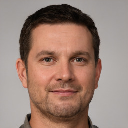 Joyful white adult male with short  brown hair and brown eyes