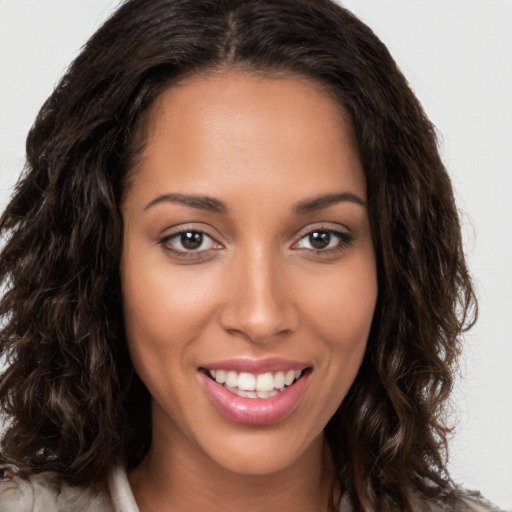 Joyful white young-adult female with long  brown hair and brown eyes