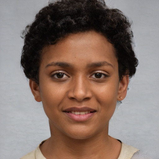 Joyful black young-adult female with short  brown hair and brown eyes