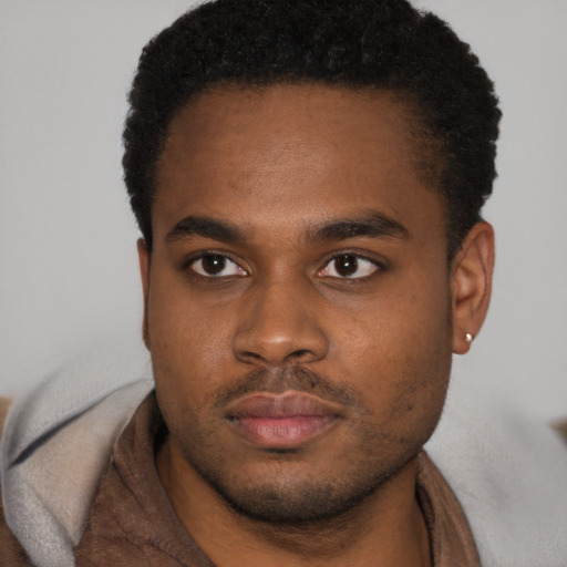 Neutral latino young-adult male with short  brown hair and brown eyes