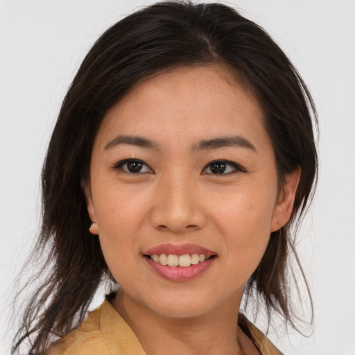 Joyful asian young-adult female with medium  brown hair and brown eyes