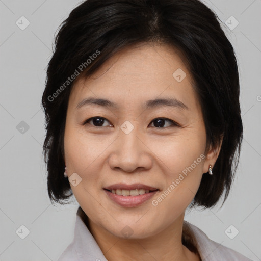 Joyful asian adult female with medium  brown hair and brown eyes