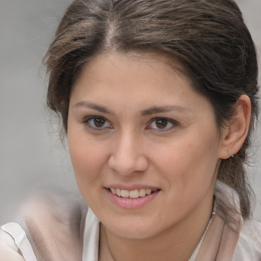 Joyful white young-adult female with medium  brown hair and brown eyes