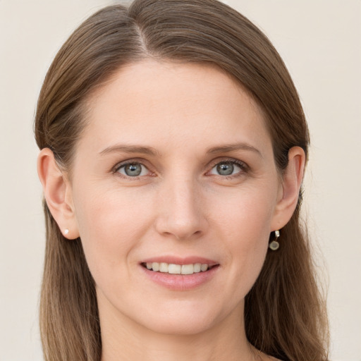 Joyful white young-adult female with long  brown hair and grey eyes