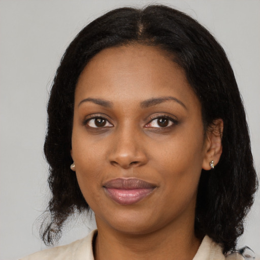 Joyful black young-adult female with medium  black hair and brown eyes