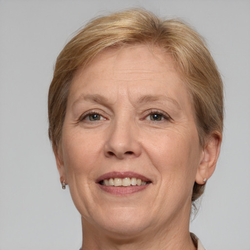 Joyful white adult female with medium  brown hair and grey eyes