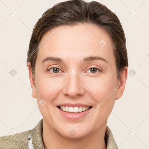 Joyful white adult female with short  brown hair and grey eyes