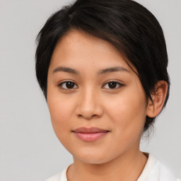 Joyful latino young-adult female with medium  brown hair and brown eyes