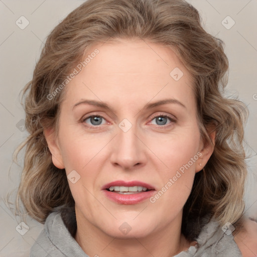 Joyful white adult female with medium  brown hair and blue eyes