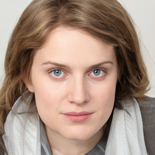 Joyful white young-adult female with long  brown hair and blue eyes