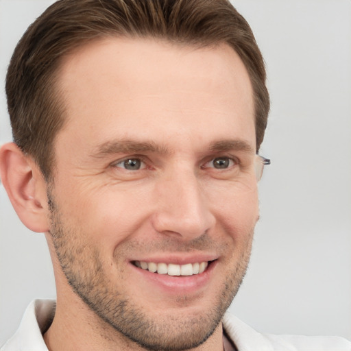 Joyful white adult male with short  brown hair and grey eyes