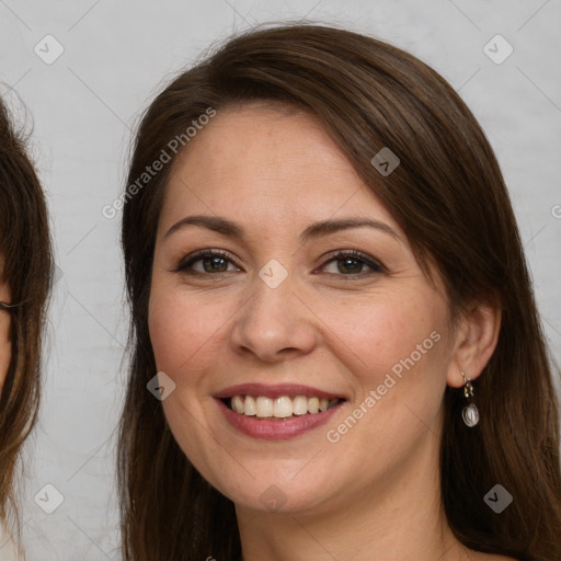 Joyful white young-adult female with long  brown hair and brown eyes