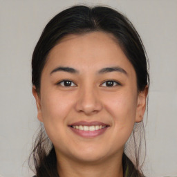 Joyful asian young-adult female with long  brown hair and brown eyes