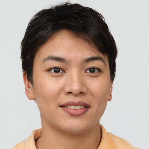 Joyful asian young-adult female with short  brown hair and brown eyes