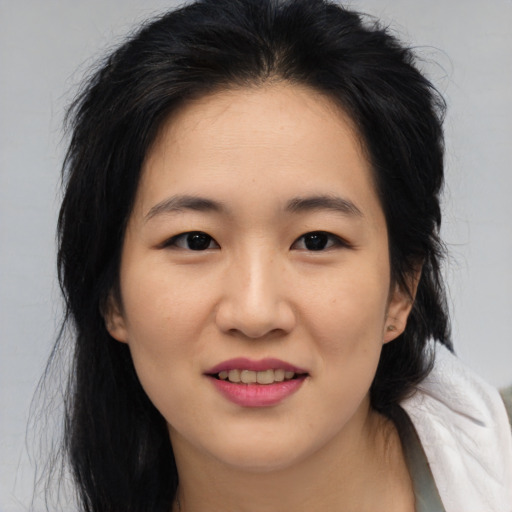 Joyful asian young-adult female with medium  brown hair and brown eyes