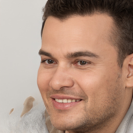 Joyful white adult male with short  brown hair and brown eyes