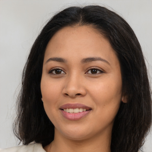 Joyful latino young-adult female with long  brown hair and brown eyes