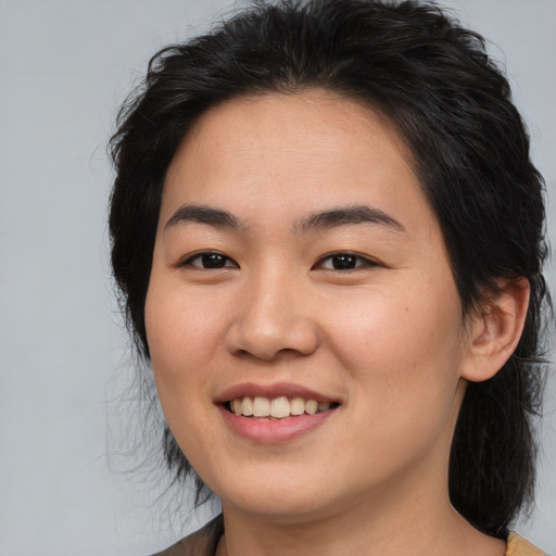 Joyful asian young-adult female with medium  brown hair and brown eyes