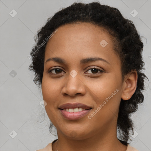 Joyful black young-adult female with long  brown hair and brown eyes