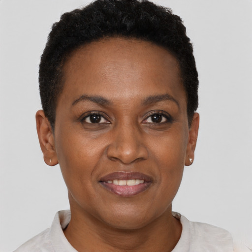 Joyful black young-adult female with short  black hair and brown eyes