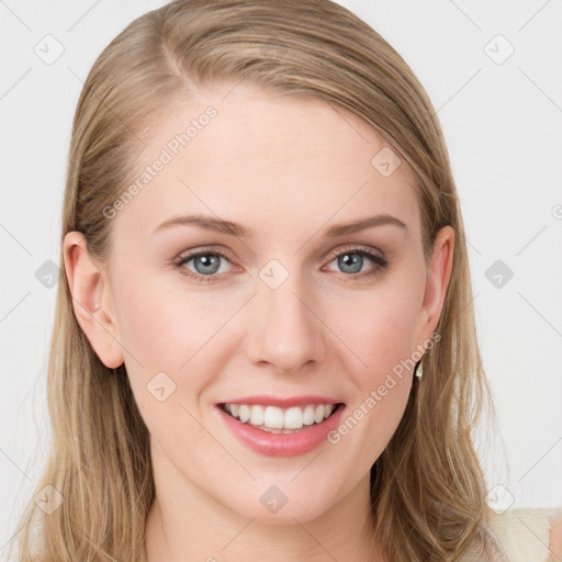 Joyful white young-adult female with long  brown hair and blue eyes