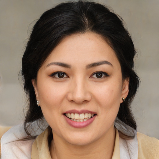 Joyful latino young-adult female with medium  brown hair and brown eyes