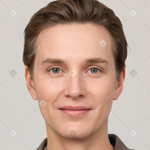 Joyful white young-adult male with short  brown hair and grey eyes